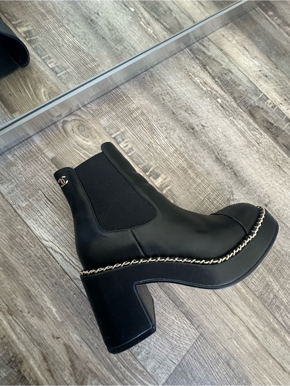 CHANEL Black Leather Chelsea Ankle Boots with Gold Chain Trim